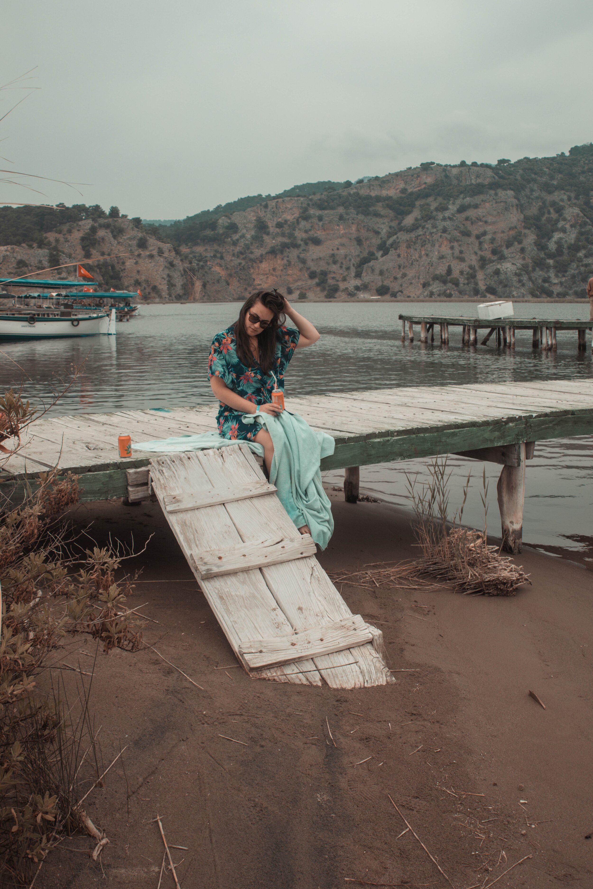 Girl on a dock thinking. Photo by courtney Hobbs on Unsplash