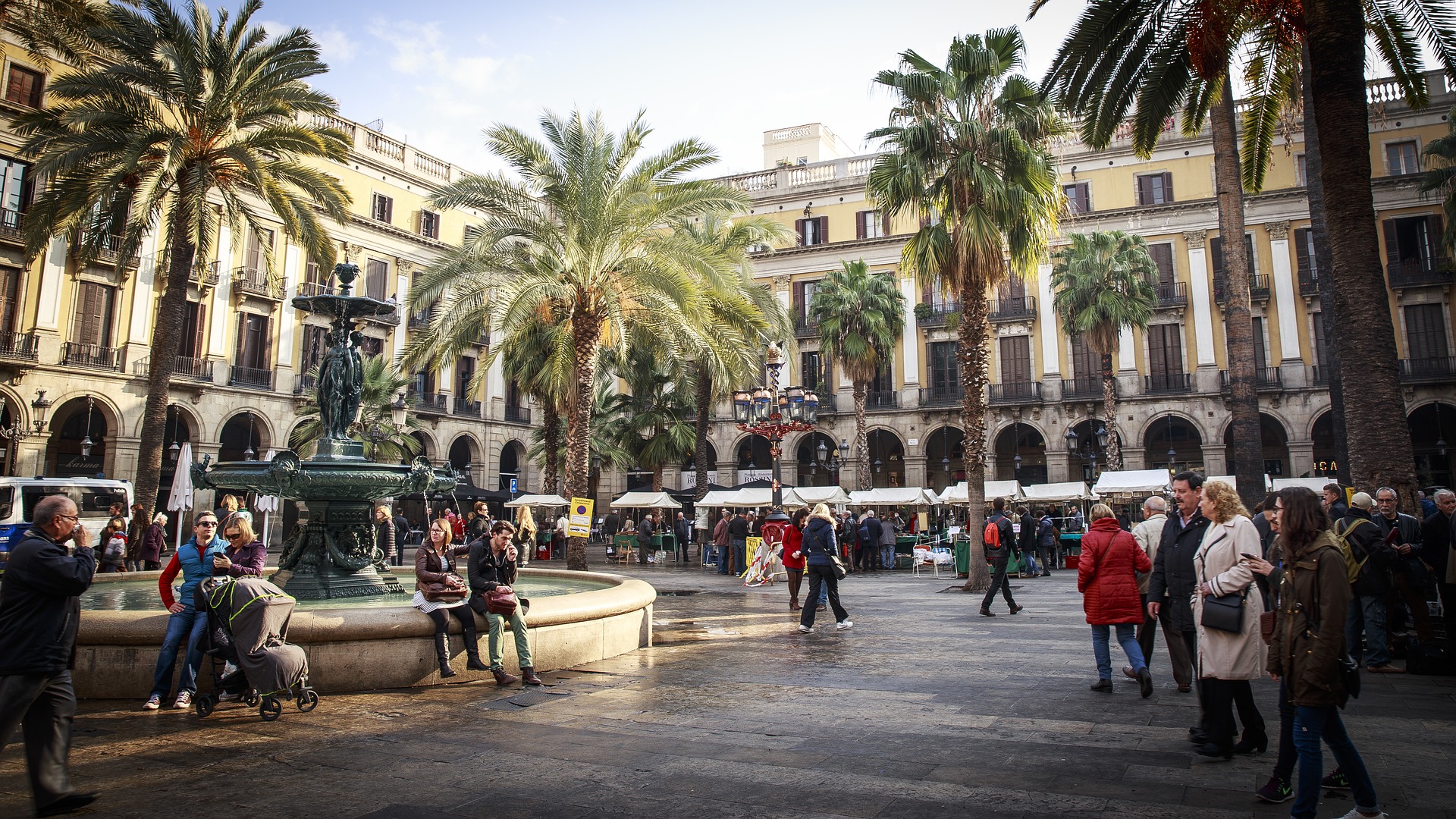 People in a square in Barcelona. Photo by skaramelka on Pixabay