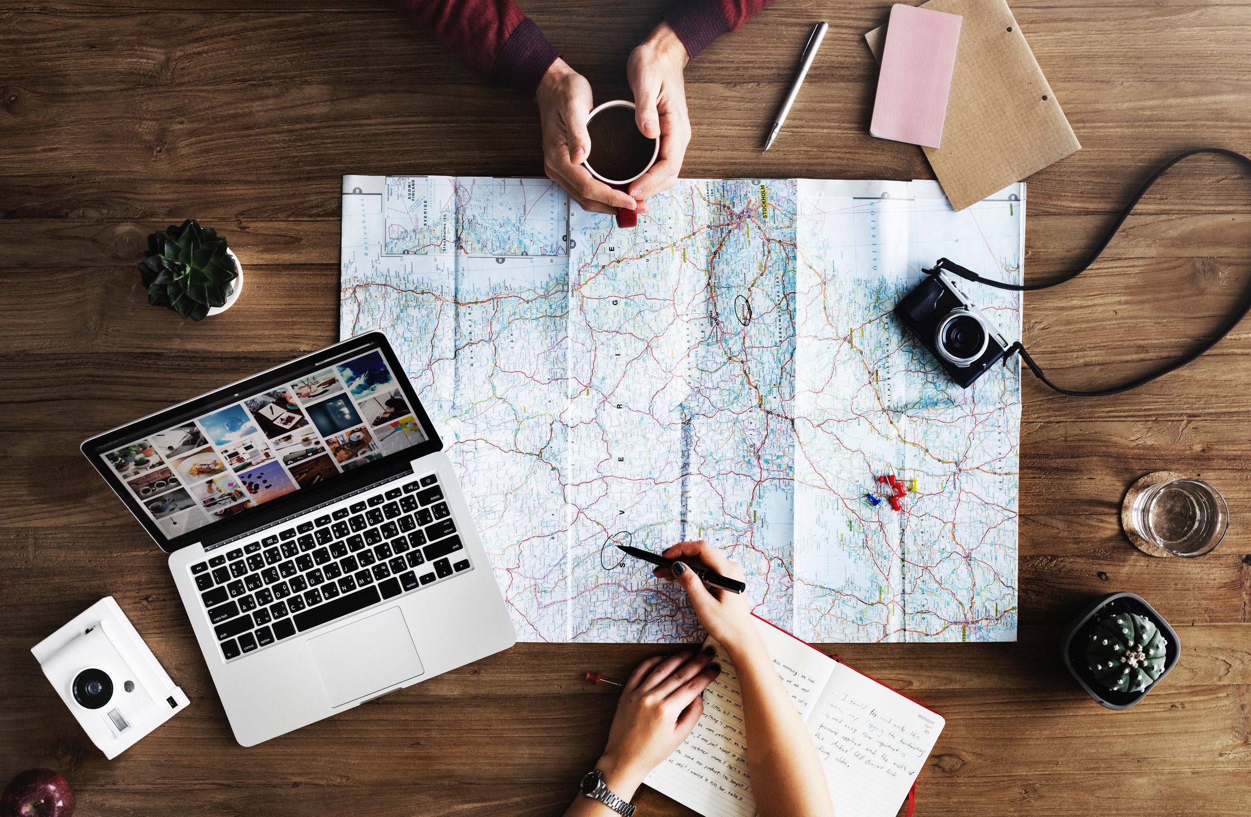 Map with people planning a trip. Photo by rawpixel on Unsplash